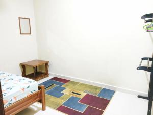 a room with a table and a rug at Hidden Homestay in Marang
