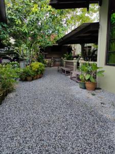 a patio with plants and a bunch of benches at Hidden Homestay in Marang