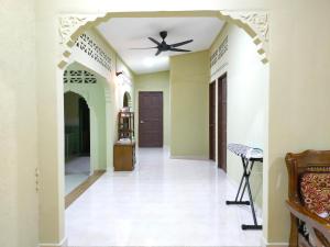 a hallway of a house with a ceiling fan at Hidden Homestay in Marang