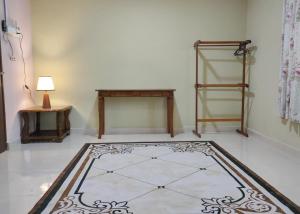 a room with a table and a tiled floor at Hidden Homestay in Marang