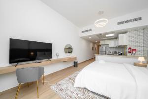a bedroom with a large tv on a wall at ALH Vacay - Modern studio vacation home in Dubai