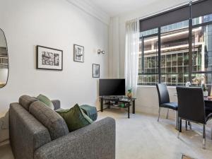 sala de estar con sofá y mesa en Cosy Central Apartment - Charming Building, en Auckland