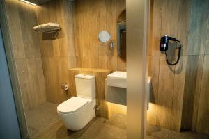 a bathroom with a toilet and a sink at Hotel Bencoolen at Hong Kong Street in Singapore