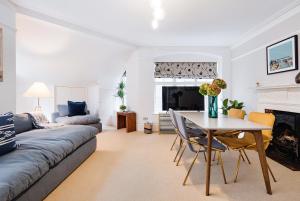 a living room with a couch and a table at ARCORE Premium Apartments Broad Court in London