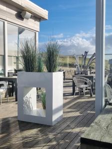 a fireplace on a deck with a view of the beach at Meerblick Wattenmeer ,50m vom Meer,Strand 300m in Westerland