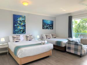 a bedroom with two beds and a window at Broadwater Keys Holiday Apartments in Gold Coast