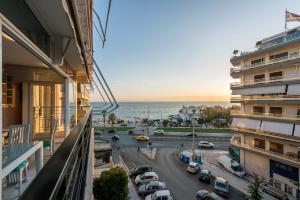 a view from the balcony of a building with a parking lot at Flisvos Elite Seafront Luxury Apartment in Athens