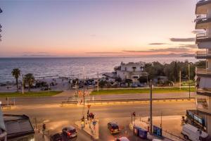 a view of a street with cars in a city at Flisvos Elite Seafront Luxury Apartment in Athens