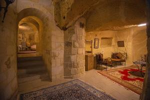 a large room with a stone wall and a hallway at Pietra Cave Suites in Ürgüp