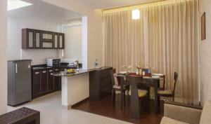 a kitchen and dining room with a table and a kitchen and a kitchen at Hotel DORTN in Pune