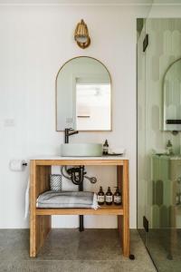 a bathroom with a sink and a mirror at The G At Gerroa in Gerroa +114 photos