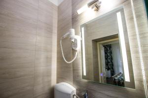 a bathroom with a sink and a mirror and a toilet at Járja Panzió in Hajdúszoboszló +30 photos