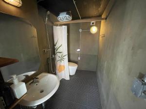 a small bathroom with a sink and a toilet at TwoTwo House in Seoul