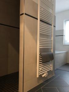 a bathroom with a towel rack and a bath tub at Gästewohnung 6 in Oschersleben