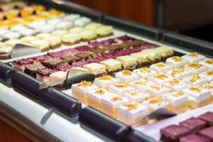 a display of different types of cheeses and other desserts at Hotel Dražica - Hotel Resort Dražica in Krk