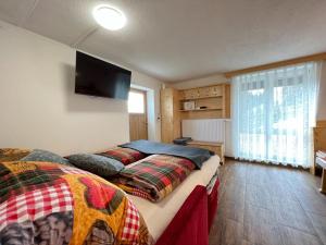 a bedroom with two beds and a flat screen tv at Cozy holiday home in Prebl with a view in the Klippitzt rl ski area in Prebl