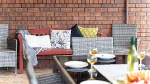 a table and chairs with pillows on a patio at The Callala Hideaway in Callala Beach +18 photos