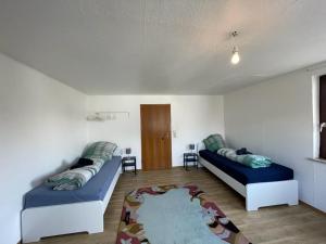 a living room with two beds and a rug at Worker Apartment Hohenstadt in Hohenstadt