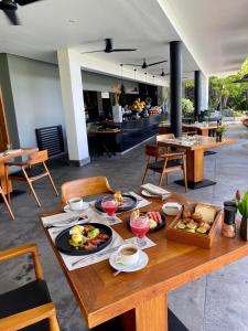 a wooden table with food on it in a restaurant at Haritha Villas & Spa in Hikkaduwa