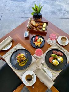 a table with plates of food and coffee on it at Haritha Villas & Spa in Hikkaduwa