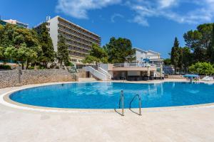 a large swimming pool in front of a building at Hotel Dražica - Hotel Resort Dražica in Krk