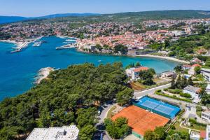 an aerial view of a resort with a tennis court and a lake at Hotel Dražica - Hotel Resort Dražica in Krk
