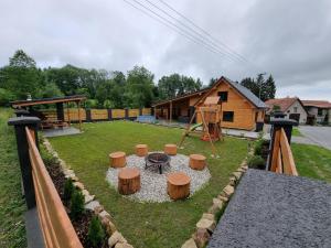 a backyard with a fire pit and a playground at Apartmán Žora in Dražov