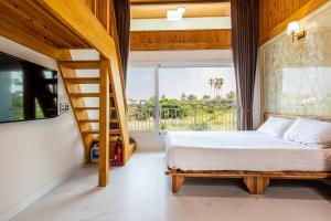 a bedroom with a bed and a staircase and a window at Aewol Oceanstay in Jeju