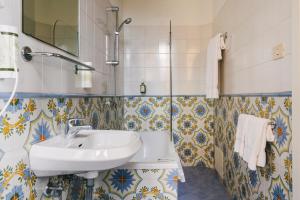 a bathroom with a sink and a mirror at Pensione Bencistà in Fiesole