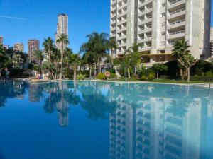 a swimming pool in front of a tall building at Gemelos 22 - Siroco in Benidorm