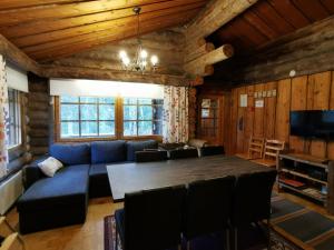 uma sala de estar com um sofá azul e uma mesa em Soppela em Syöte