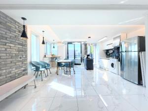 a kitchen and dining room with a brick wall at W Guesthouse Incheon airport in Incheon