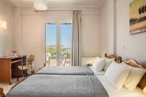 Postel nebo postele na pokoji v ubytování Rhakotis Villa