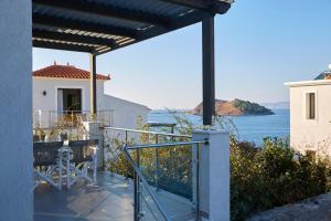 a balcony with a view of the ocean at Eleia Seafront Rooms & Villas in Petra