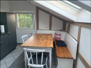 a small kitchen with a wooden table and chairs at Haus Eckert in Höchenschwand