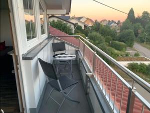 a balcony with two chairs and a table at Haus Eckert in Höchenschwand