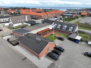 an aerial view of a town with cars parked in a parking lot at Hvide Sande Inn in Hvide Sande