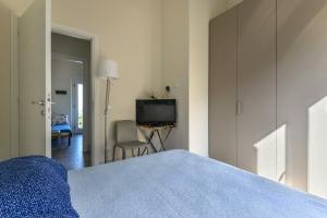 a bedroom with a bed and a television in it at Il Quartiere apt Capraia in Pomonte