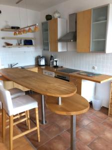 een keuken met een houten tafel en een aantal stoelen bij FeWo Kronsberg in Eldingen