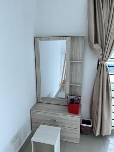 a mirror sitting on a dresser next to a table at 53 Mountainville Semi-D Bungalow-13-18pax in Ipoh