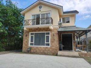 a small house with a balcony on top of it at Cheers乾杯包棟民宿 in Yuanshan