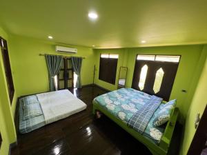 Postel nebo postele na pokoji v ubytování Sukhothai City Resort