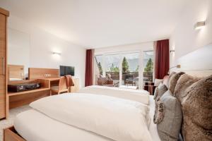 Postel nebo postele na pokoji v ubytování Alpen-Comfort-Hotel Central