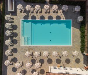 an overhead view of a swimming pool with chairs and umbrellas at Villa Carobbi Apartments Florence in Florence
