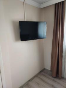 a flat screen tv on the corner of a room at Larsens Suit Hotel in Alanya