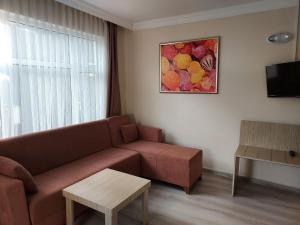 a living room with a couch and a table at Larsens Suit Hotel in Alanya
