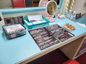 a table with cosmetics and other items on it at Hua Ku Hotel in Tainan