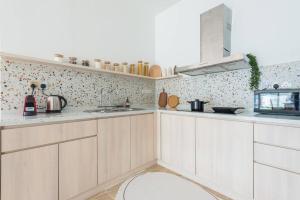 a kitchen with white cabinets and a sink at Penthouse Hermès in Kuala Lumpur