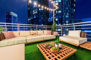 a balcony with a couch and a table with fruit on it at Penthouse Hermès in Kuala Lumpur