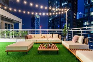 a patio with couches and a table on a balcony at Penthouse Hermès in Kuala Lumpur +22 photos